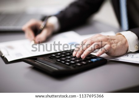 Man doing his accounting, financial adviser working
