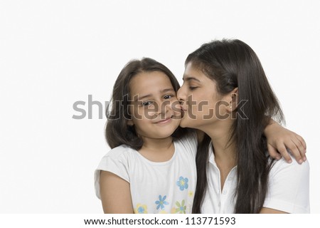 Close-up of a woman kissing her daughter