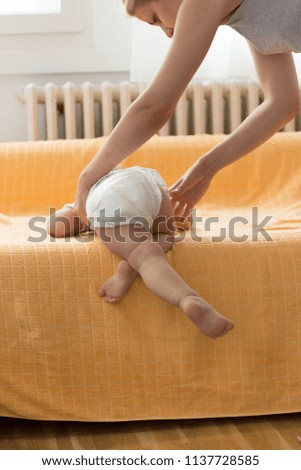 sequence photos of toddler climbing down and try to get off from bed. Baby development and self learning