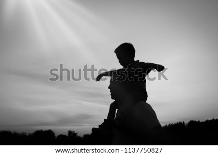 Happy parent with children playing on nature summer silhouette