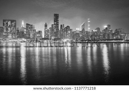 Black and white picture of Manhattan at night, New York City, USA.