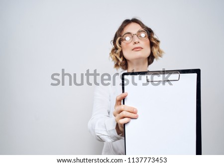    place free business woman in glasses holds a folder-tablet with an empty sheet of paper office career                            