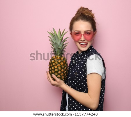 Portrait of beautiful young woman with pineapple on color background