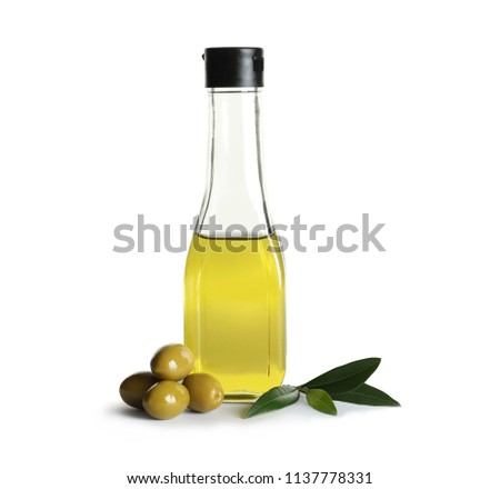 Glass bottle with fresh olive oil on white background