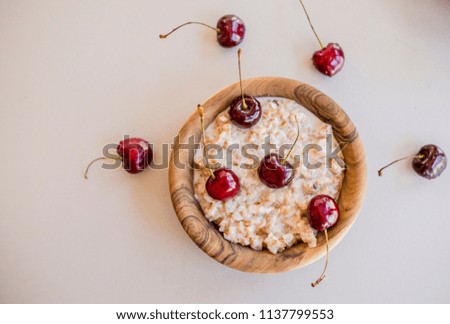 Fresh ripe bird cherries with porridge close up shot