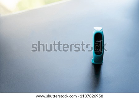 fitness clock smart band device blue color on black background