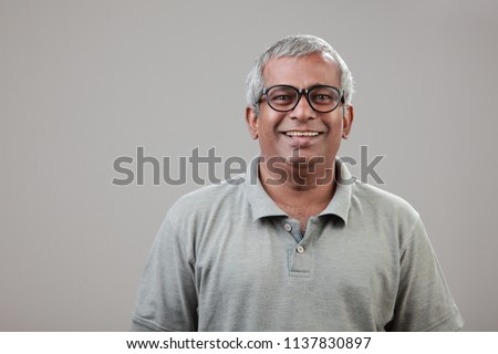 Portrait of a middle aged man of Indian origin Royalty-Free Stock Photo #1137830897