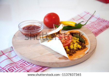 mexican tortilla wrap with chicken breast meat and vegetables