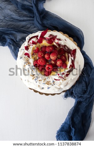 Pavlova dessert with berries and caramel. White background