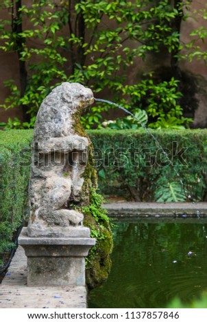 Seville, Spain - June 2018: The fountain in the park of the Alcazar palace in Seville, Spain, Europe. Royal place.