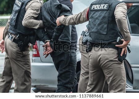 Police arrested the culprit,Police steel handcuffs,Police arrested,Police arrested the wrongdoer. Royalty-Free Stock Photo #1137889661