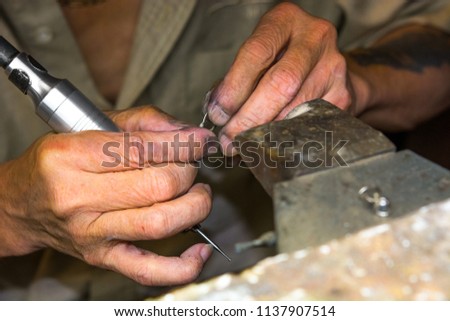 Pictures showing the process of creating jewelry and sizing rings and setting stones.