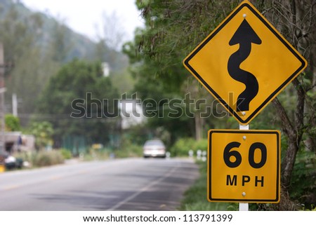 Speed limit sign and winding Road Sign