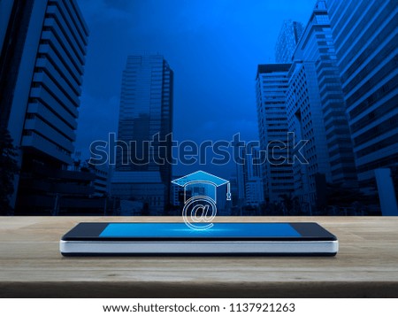 e-learning icon on modern smart phone screen on wooden table over office city tower, Study online concept