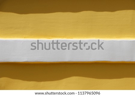 Yellow wall with a white horizontal line. View number two. Minimalism. Background.