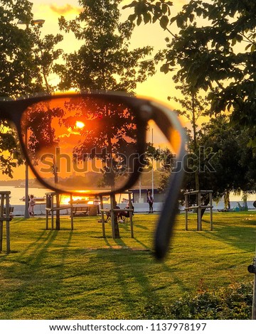 Holding a Polarised Sunglasses to the Sun Royalty-Free Stock Photo #1137978197