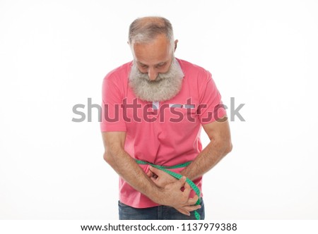 Senior man measuring waist with a tape. Lose weight concept.