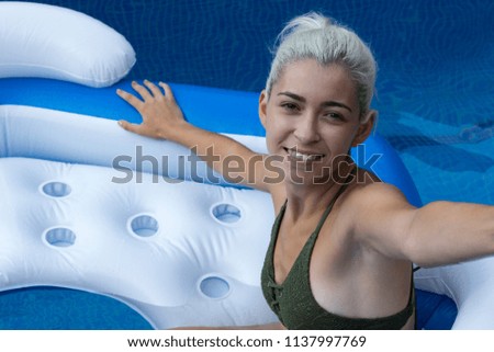 Cute young woman in pool	
