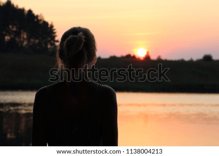 Girl looks at the sunset
