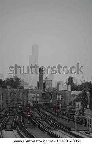 Chicago subway tracks black and white shot with red accents of the subway light signals