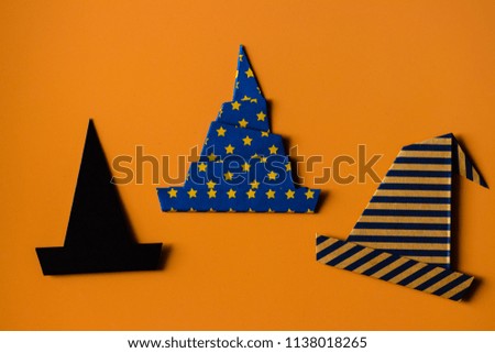Origami for kids : collection of witch hat made from folded paper on orange background isolated.Top view, flat lay.Easy to use for card.Happy halloween.