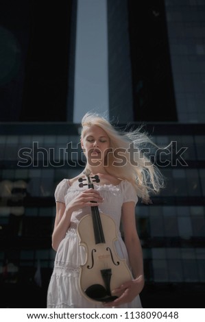 White girlwith violin in the city street