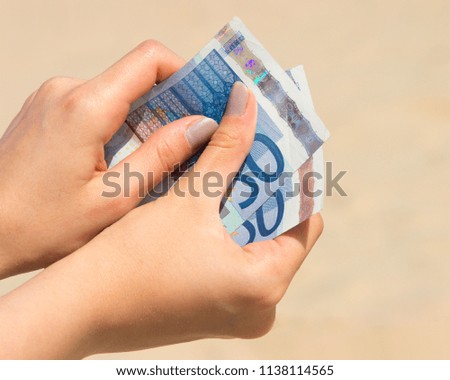 euro banknotes in the girl's hand
