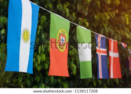  flags outdoor against green tree Royalty-Free Stock Photo #1138117208