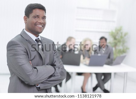 successful young businessman on background of office