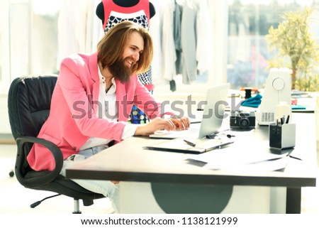 Concentrated man working on laptop and doing home design
