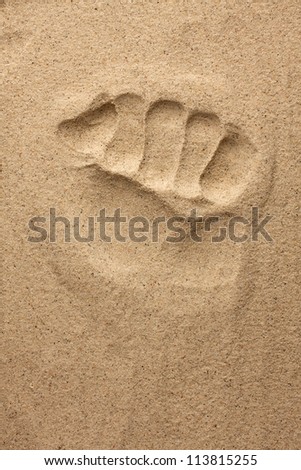 The imprint of man's hand in the sand