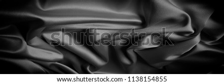  texture of black and white silk fabric This high-quality charmeuse is made of satin weave, yet elastic and beautifully adorns. The front of the fabric has a satin finish, shiny and reflective