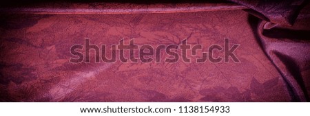 Texture, background, pattern. fabric silk dark maroon. Silk organza mood, but with a beautiful satin face. This fabric has a crunchy drape of organza, but one face is a brilliant satin.