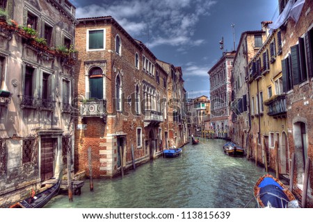 Boats & Gondola down a street canal off the Grand Canal in Venice, Italy Royalty-Free Stock Photo #113815639