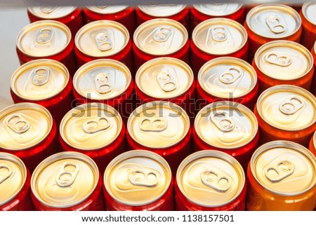 many aluminum cans with drinks top view