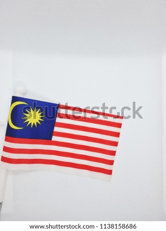 Malaysia national flag or Jalur Gemilang. Concept of Malaysia Day independence celebration. Isolated on white background. Slightly de-focused and close-up shot. 