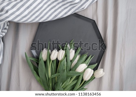 Bouquet of white tulips on a gray background