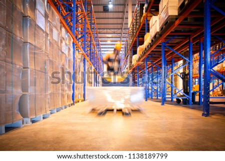 Warehouse forklift working in large warehouse