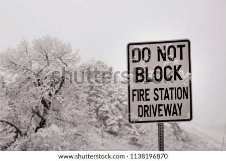 Do not block sign outside a fire station during a snowy winter in Colorado