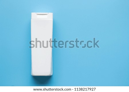 White plastic bottle shampoo and conditioner on blue background