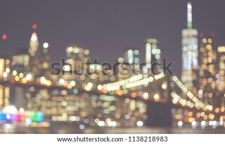 Blurred picture of New York City skyline at night, color toned picture, urban abstract background.