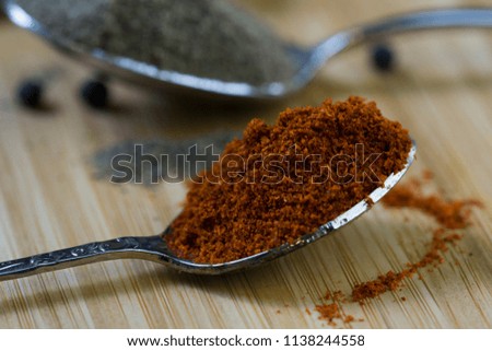 Spices on teaspoons. Chili close up picture. 