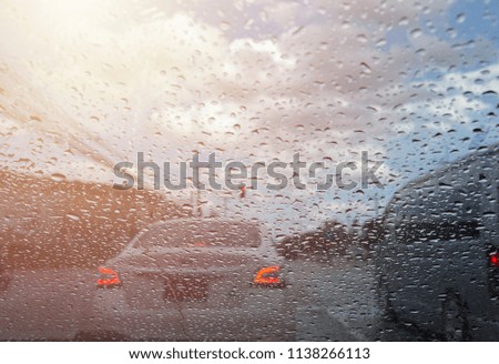 Rain drops on car glass and light.