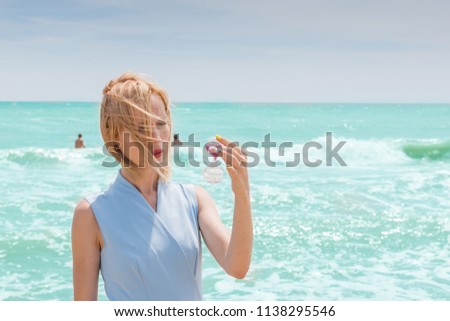 Women holding hourglass and sea background, concept travel in summer  