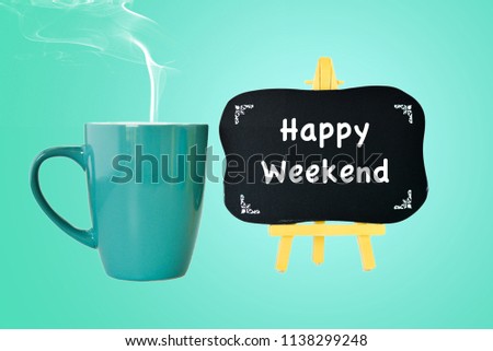 Cyan coffee mug and chalk board on cyan background. happy weekend. selective focus.