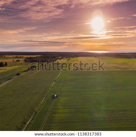 image from drone view. Sunset over a forest and meadow