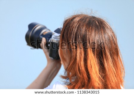 girl with a camera taking pictures