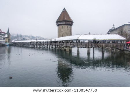 Lucerne switzerland. Cityscape view of Chapel bridge and historic city center of Lucerne with famous lake Lucerne (Vierwaldstattersee) in beautiful winter day with snow, Canton of Luzern, Switzerland