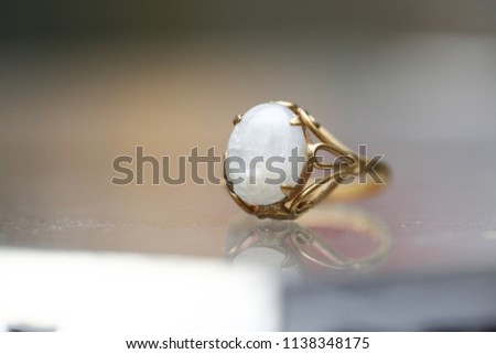 Opal white gem stone on gold ring
