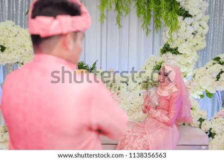 Muslim wedding couple wearing Malay traditional  dress on Malay wedding ceremony